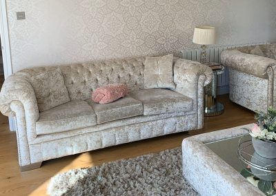 Interior decorator arranging furniture and decor in a modern Gloucester home